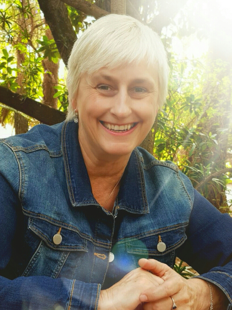 Professor Zelda G. Knight smiling warmly in a garden setting